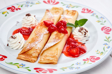crepes with strawberry sauce and whipped cream