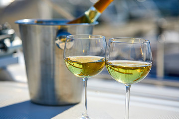 Pair of wineglasses against the yacht