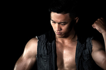 Fototapeta na wymiar Asian muscle men posing muscle abs on the black background | Asian Sexy Men fashion