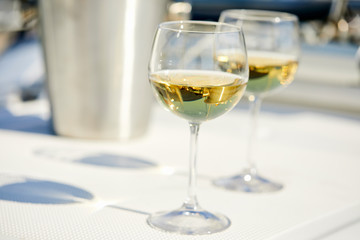 Pair of wineglasses against the yacht