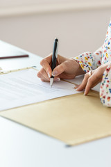 Closeup of businesswoman signing contract