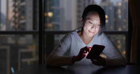Woman use mobile phone online at home