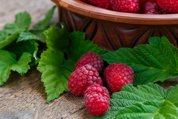 Fresh ripe raspberries on the wooden table