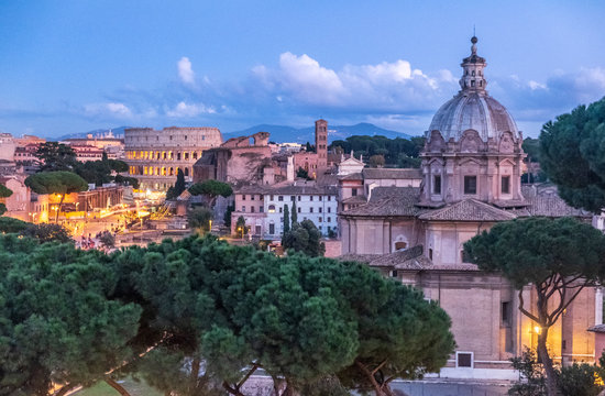 Italy, Rome, Chiesa di San Lorenzo in Miranda and Colosseum in the evening light