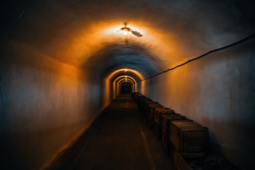 Long corridor or illuminated tunnel in bomb shelter, underground military bunker of cold war,...