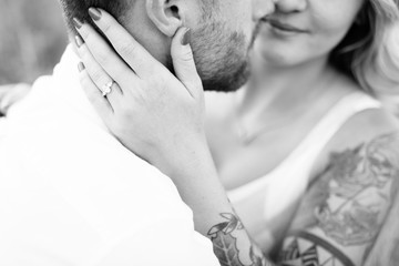 Romantic lose up of engagement ring on woman's hand in an embrace