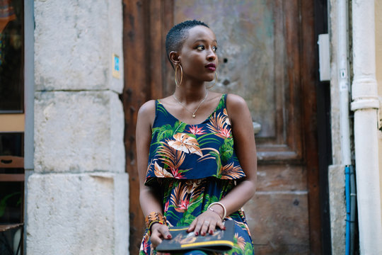 Woman sitting on the side of the street