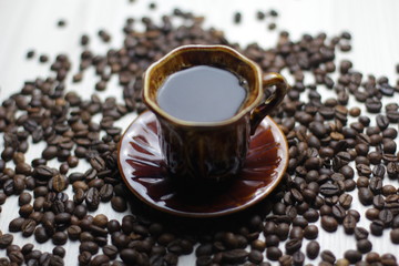 Cup of tasty coffe with a coffe background