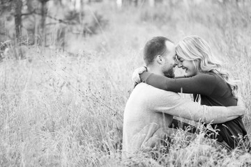 Young happy couple embracing in grassy field