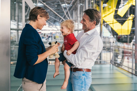 Small boy being happy upon his business mother's arrival at the airport