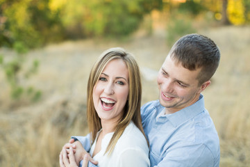 Obraz premium young beautiful couple laughing and hugging