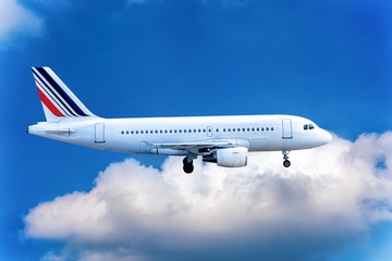 Big jet flying on background of cloudy blue sky.