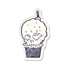 retro distressed sticker of a cartoon spooky skull cupcake