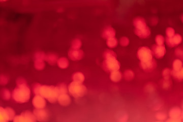 Abstract blurred background for layouts. On a red background, bright spots in defocus. Light photo.