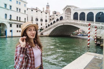 Woman in the Venice, standing on the pier on the grand canal. Discovering Venice Italy.