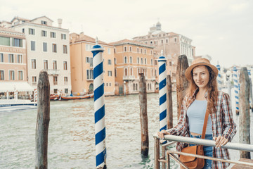 Woman in the Venice, standing on the pier on the grand canal. Discovering Venice Italy.