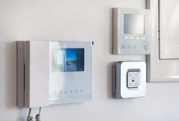 Close up wall with security alarm and video intercom