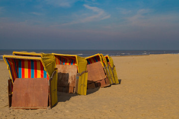 yellow beach chairs on a sunny beach waiting to be stored till the next season