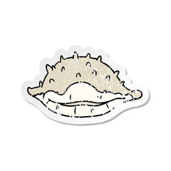 distressed sticker cartoon doodle of a sea shell