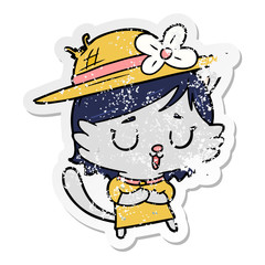 distressed sticker of a cartoon cat wearing hat