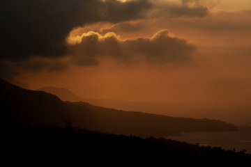 colorful sunset over tenerife behind clouds