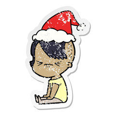 distressed sticker cartoon of a annoyed hipster girl wearing santa hat