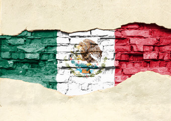 National flag of Mexico on a brick background. Brick wall with partially destroyed plaster, background or texture.