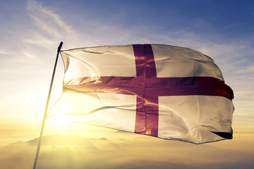 England flag waving on the top sunrise mist fog