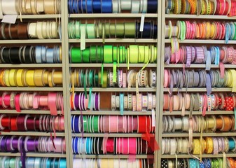 sewing haberdashery haberdasher ribbon reels rolls rows and trims in fabric retail shop  sew sewing supplies for sale retail shop market rainbow stock, photo, photograph, image, picture,  - obrazy, fototapety, plakaty
