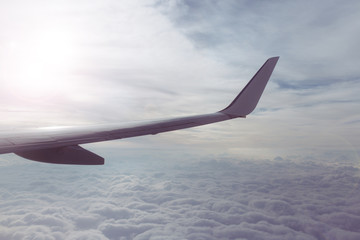 Fototapeta na wymiar Über den Wolken im Flugzeug - In the clouds
