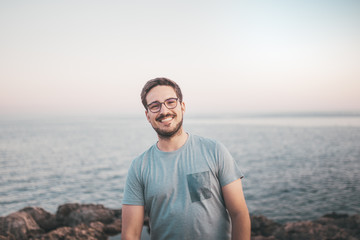 Fototapeta na wymiar Mann mit Brille lächelt beim Urlaub am Strand 
