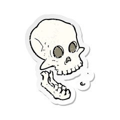 retro distressed sticker of a cartoon laughing skull
