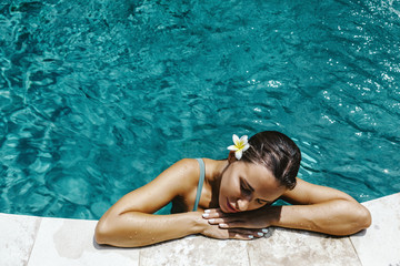 Woman relaxing in swimming pool