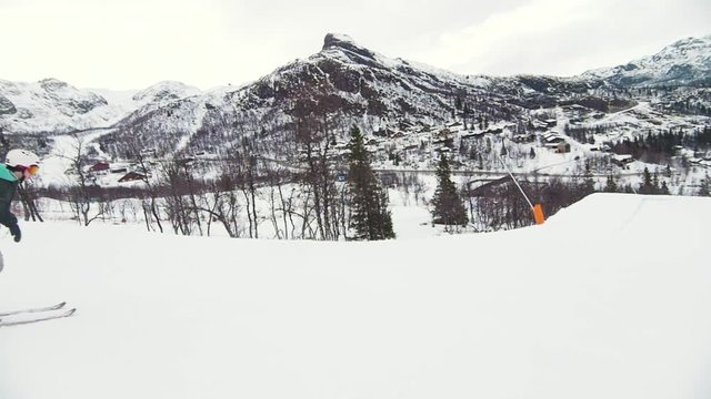 Skier doing a big backflip on a big jump, at at the ski resort