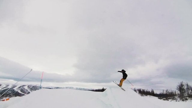Skier doing a 360 on a big jump, at the ski resort.