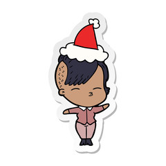 sticker cartoon of a squinting girl wearing santa hat