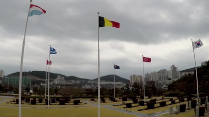 Belgian Flag Waving in the air of UN Memorial Cemetery in Busan, South Korea, Asia - Powered by Adobe