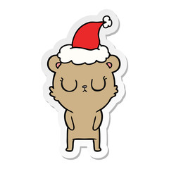 peaceful sticker cartoon of a bear wearing santa hat