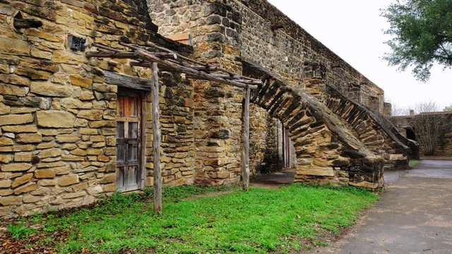 first person view walking past a old fort gates at the old mission