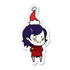 sticker cartoon of a friendly vampire girl wearing santa hat