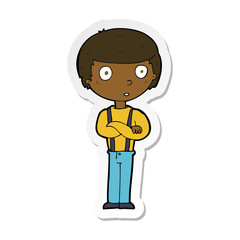 sticker of a cartoon staring boy with folded arms