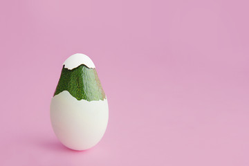 Beautiful creative decoration background idea concept for vegan easter with fresh green avocado