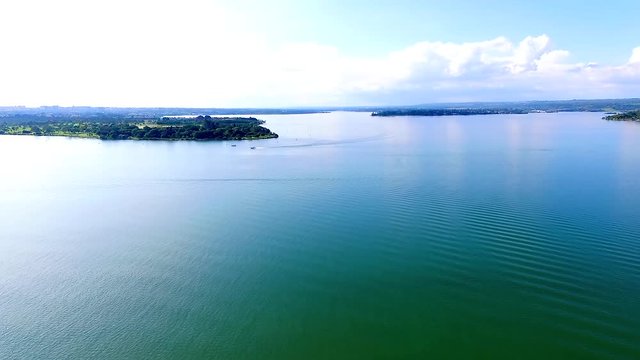 Drone / aerial footage above Brasilia's lake (Lago Paranoa), Brazil capital's - summer season.