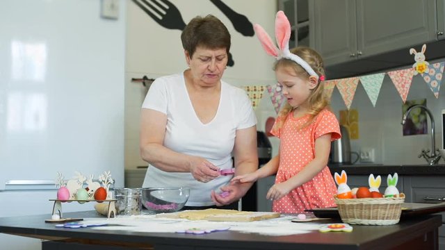 Grandma and Granddaughter Baking Easter Cookies