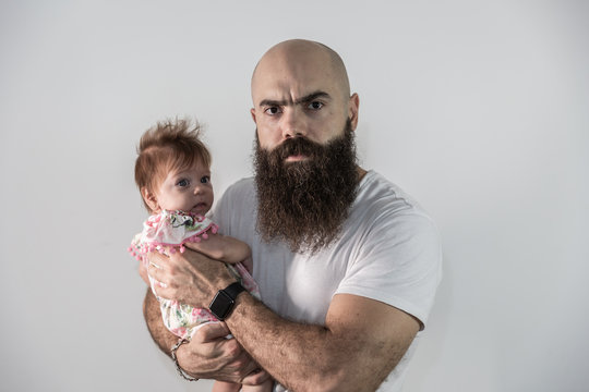 Furious man protecting his daughter so no boy comes close. Concept of father who does not want his daughter to date or overprotective parents.