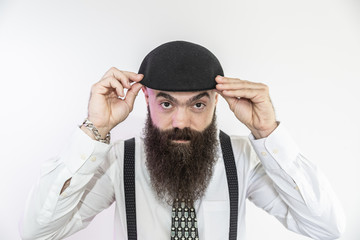 Bearded man looking at the camera. Concept of masculinity and care with the beard. Pointing with finger, approving or indicating.