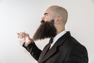 barber with long beard using scissors