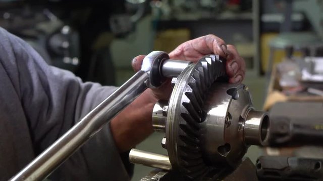 Mechanic using torque wrench on differential