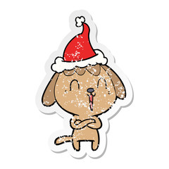 cute distressed sticker cartoon of a dog wearing santa hat