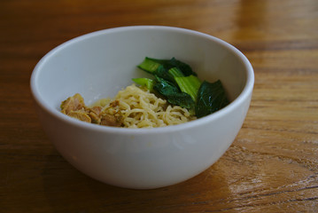 Chicken noodle with green veggie in bowl